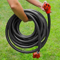 Hand Holding Coiled Valterra 50 Amp RV Extension Cord with Red Female End Outdoors - In Use | United RV Parts