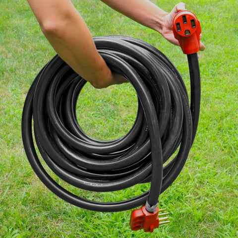Hand Holding Coiled Valterra 50 Amp RV Extension Cord with Red Female End Outdoors - In Use | United RV Parts
