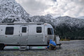 AIRSKIRTS Inflatable RV Skirt Installation - Person Fitting Skirt Tube on Airstream Trailer | United RV Parts