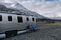 AIRSKIRTS RV Skirting Kit Setup - Person Installing Inflatable Skirt on Airstream Side Panel | United RV Parts