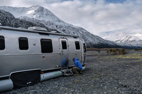 AIRSKIRTS RV Skirting Kit Setup - Person Installing Inflatable Skirt on Airstream Side Panel | United RV Parts