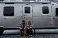 AIRSKIRTS Inflatable Trailer Skirt Kit - Couple Seated Outside Skirted Airstream in Winter | United RV Parts