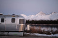 AIRSKIRTS Inflatable RV Skirting - Airstream Trailer Front Corner View at Winter Lakeside Camp | United RV Parts