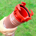 Hand Holding Red Valterra EZ Coupler RV Sewer Hose Adapter - Bayonet Lock Detail Close-Up | United RV Parts