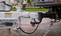 Red Coiled Breakaway Cable Installed on RV Hitch - Outdoor Setting | United RV Parts