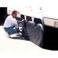 Person Installing Black ADCO Double Axle Tyre Gard on RV Tandem Tires - Installation View | United RV Parts