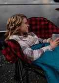 Red Plaid Kuma Heated Camping Love Seat Beside Airstream RV - Lifestyle Scene | United RV Parts