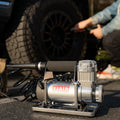 Silver Viair 300P RVS Portable Air Compressor on Ground Next to RV Tire - Lifestyle | United RV Parts