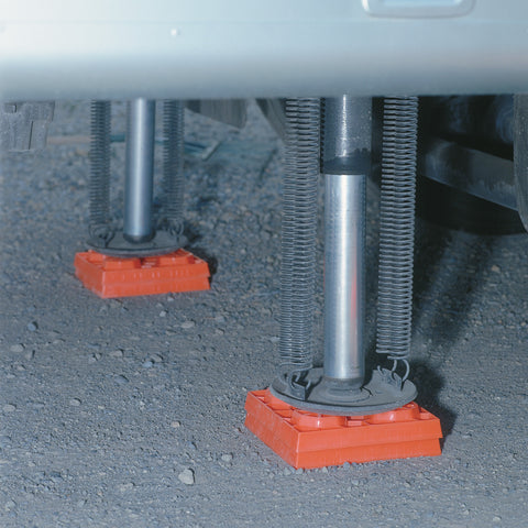 Orange Lynx Levelers Supporting RV Stabilizer Jacks - Underside View | United RV Parts