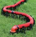 Valterra Slunky RV Sewer Hose Support Cradle Supporting Red Hose on Grass - In-Use Lifestyle | United RV Parts