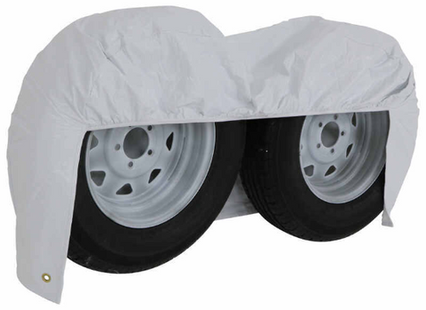 White Vinyl ADCO Double Axle Tire Cover Draping Both Wheels - Angle View | United RV Parts