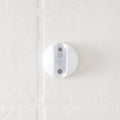 White Round RV Shower Head Wall Mount Bracket with Screws Installed on Tile - Close-Up Detail | United RV Parts
