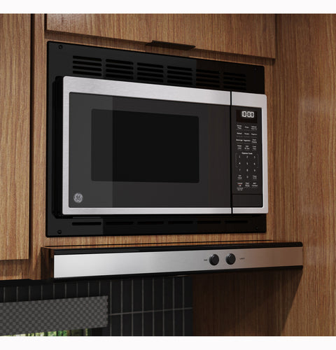 GE RV Microwave GCBK09N1WSS with Black Trim Kit in RV Kitchen Cabinet - Angled Side View | United RV Parts