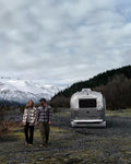 Silver Airstream Trailer with Inflatable RV Skirting - Mountain Camping Scene | United RV Parts
